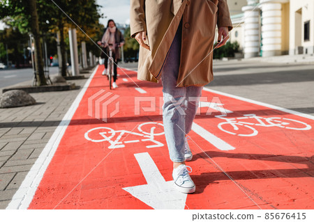 feet walking along bike lane or road for bicycles 85676415
