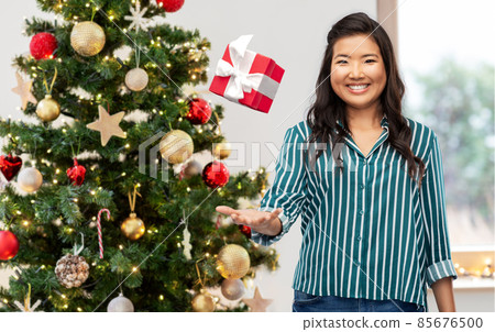 happy asian woman with birthday present happy asian woman with birthday present 85676500