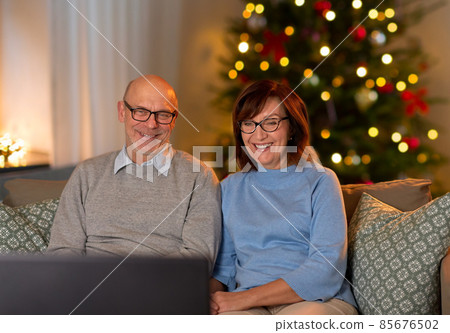 happy senior couple watching tv on christmas happy senior couple watching tv on christmas 85676502