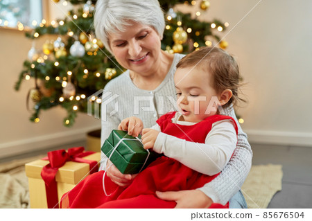 grandmother and baby girl with christmas gift grandmother and baby girl with christmas gift 85676504