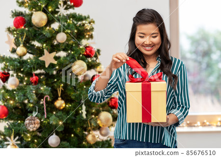 happy asian woman opening gift box happy asian woman opening gift box 85676510