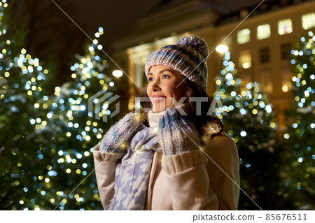 happy woman walking in christmas city in winter happy woman walking in christmas city in winter 85676511