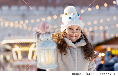 happy little girl with christmas lantern in winter happy little girl with christmas lantern in winter 85676513