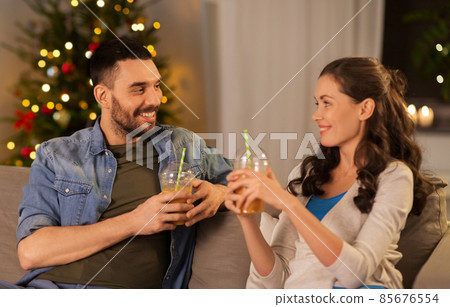 happy couple drinking takeaway juice on christmas happy couple drinking takeaway juice on christmas 85676554