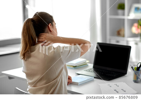 tired teacher with laptop touching neck at home 85676809