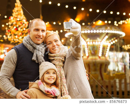 happy family taking selfie at christmas market 85676873