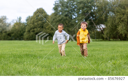 happy little boys running at park happy little boys running at park 85676927