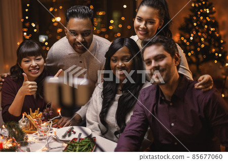 friends taking selfie on christmas dinner at home 85677060