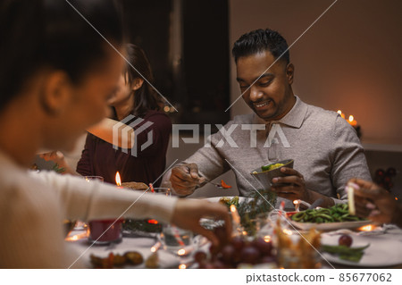 happy friends having christmas dinner at home happy friends having christmas dinner at home 85677062