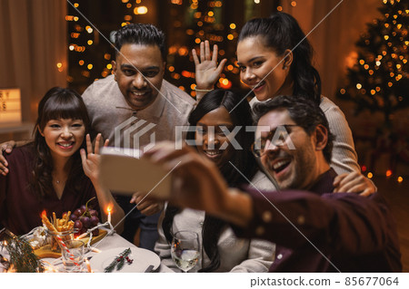 friends taking selfie on christmas dinner at home 85677064