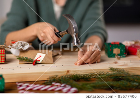 woman making advent calendar on christmas at home 85677406