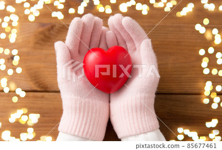 hands in pink woollen gloves holding red heart hands in pink woollen gloves holding red heart 85677461