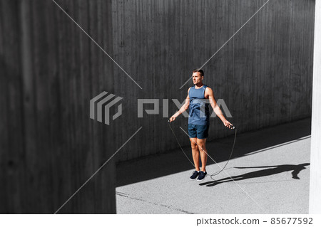 man exercising with jump-rope outdoors 85677592