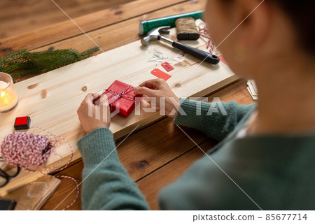 woman making advent calendar on christmas at home woman making advent calendar on christmas at home 85677714