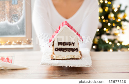close up of woman holding gingerbread house close up of woman holding gingerbread house 85677818