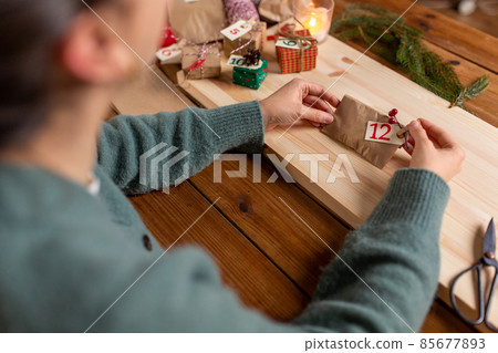 hands making christmas advent calendar at home hands making christmas advent calendar at home 85677893