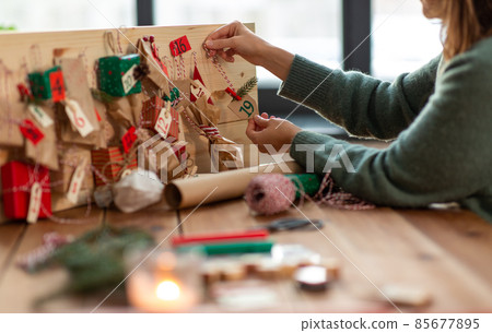 hands making christmas advent calendar at home hands making christmas advent calendar at home 85677895