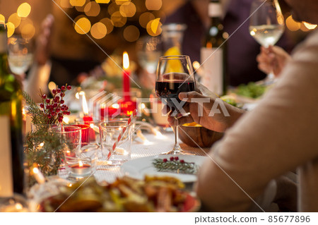 close up of man drinking wine at christmas party close up of man drinking wine at christmas party 85677896