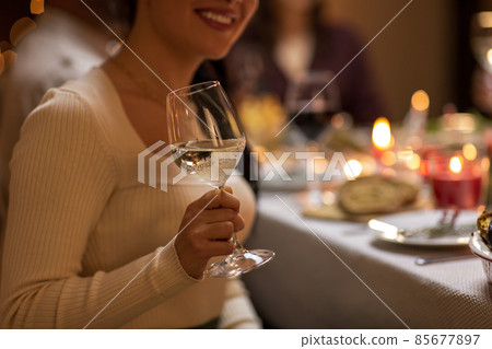 close up of woman drinking wine at christmas party close up of woman drinking wine at christmas party 85677897