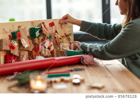 hands making christmas advent calendar at home 85678128