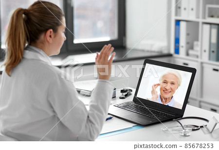 doctor with laptop having video call with patient 85678253