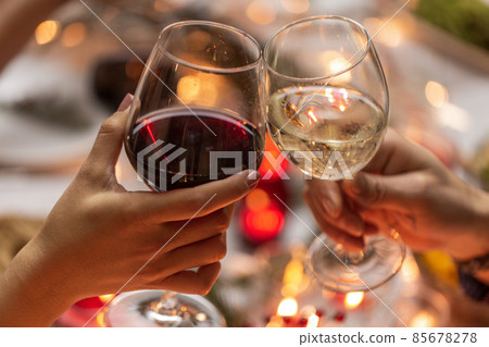close up of hands toasting wine at christmas party 85678278