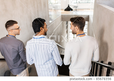 men walking down office stairs and talking men walking down office stairs and talking 85678356