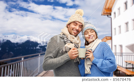 happy couple with mugs drinking coffee in winter happy couple with mugs drinking coffee in winter 85678476