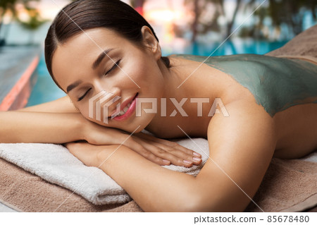 woman with blue clay mask in spa over beach woman with blue clay mask in spa over beach 85678480