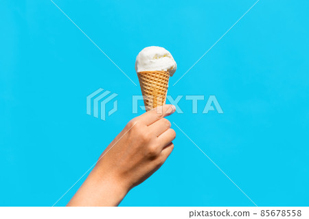 close up of hand holding waffle ice cream cone close up of hand holding waffle ice cream cone 85678558