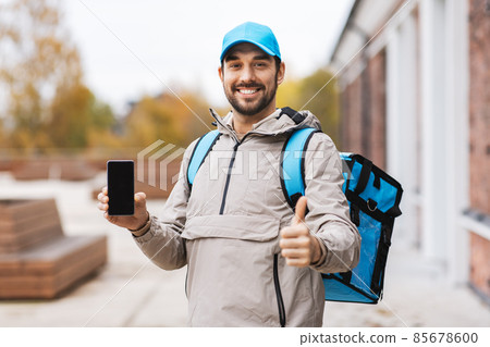 delivery man with phone and thermal bag in city delivery man with phone and thermal bag in city 85678600