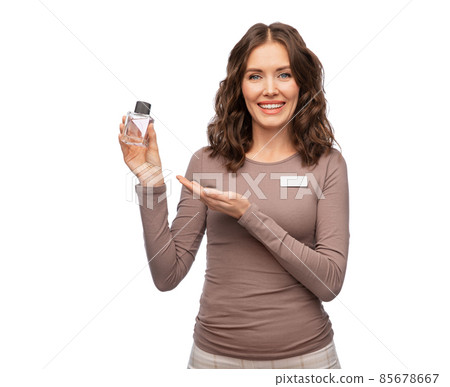 happy female shop assistant with perfume happy female shop assistant with perfume 85678667