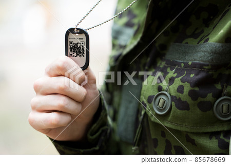 close up of young soldier with qr code on dog tag 85678669