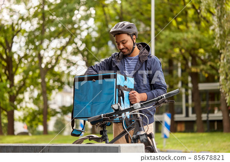 delivery man with food bag and bicycle in city delivery man with food bag and bicycle in city 85678821