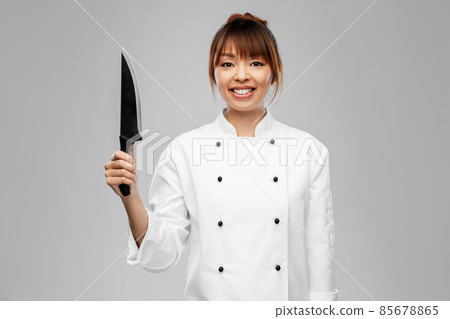 smiling female chef with kitchen knife smiling female chef with kitchen knife 85678865