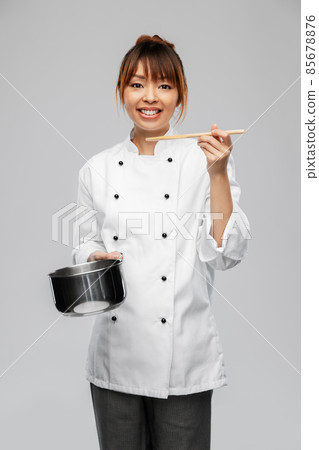 female chef with saucepan tasting food female chef with saucepan tasting food 85678876