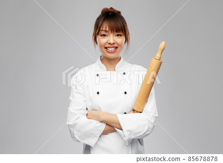 smiling female chef or baker with rolling pin smiling female chef or baker with rolling pin 85678878
