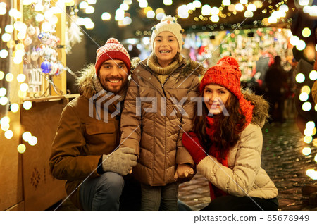 happy family at christmas market in city 85678949
