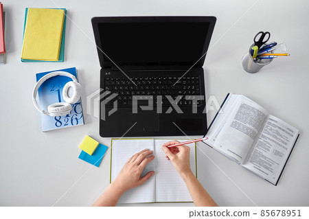 hands of student with notebook and laptop on table hands of student with notebook and laptop on table 85678951
