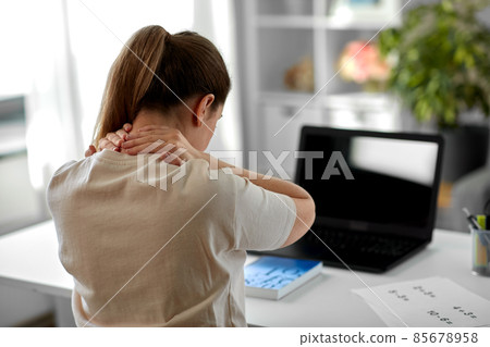 tired teacher with laptop touching neck at home 85678958