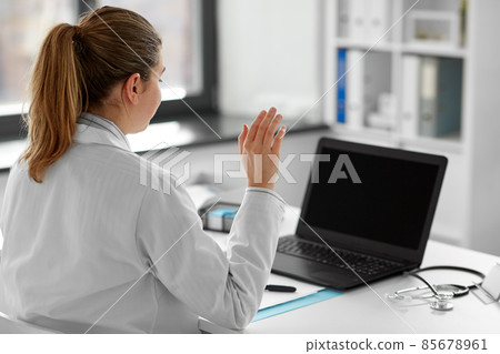 doctor with laptop having video call at hospital 85678961