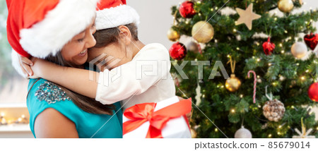 happy mother and daughter over christmas tree 85679014