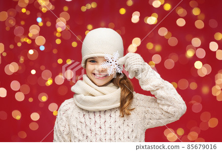 girl with big snowflake over christmas lights 85679016