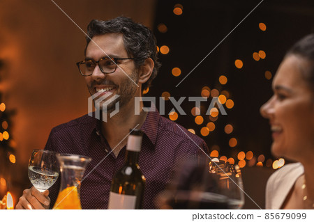 happy friends drinking wine at christmas dinner happy friends drinking wine at christmas dinner 85679099