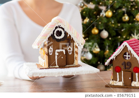 close up of woman with christmas gingerbread house close up of woman with christmas gingerbread house 85679151