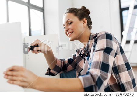 woman assembling furniture at home 85679270