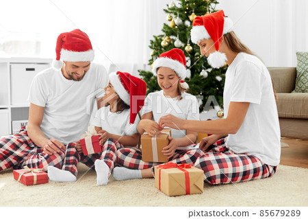 happy family opening christmas gifts at home happy family opening christmas gifts at home 85679289