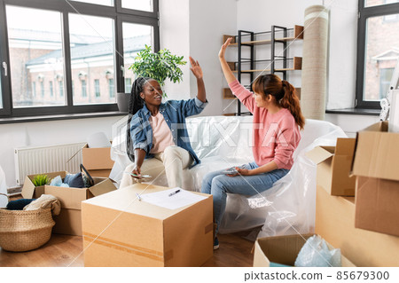 happy women moving to new home and counting money 85679300