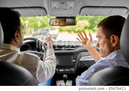 car driving school instructor teaching male driver car driving school instructor teaching male driver 85679411