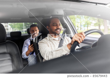 indian male driver driving car with passenger indian male driver driving car with passenger 85679443
